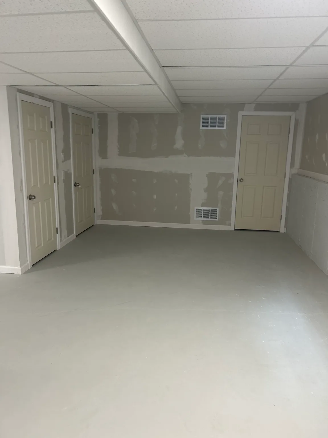 Suspended ceiling grid with acoustic ceiling tiles installed by Mass Framing Solutions