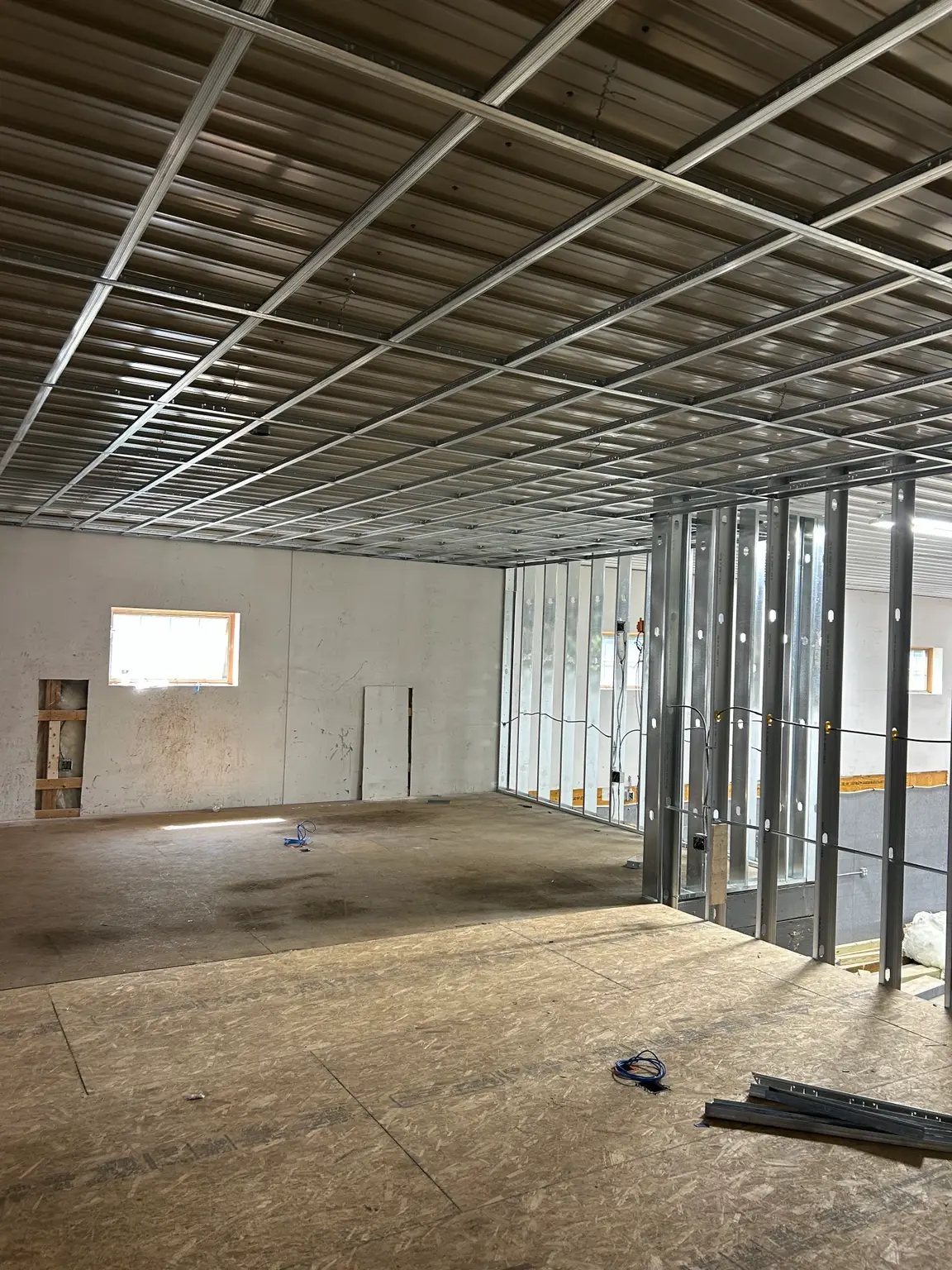 Interior metal stud framing and steel ceiling grid installed by Mass Framing Solutions